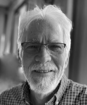 Pat Selvey's black-and-white headshot. A distinguished souther gentleman with white hair, glasses, and a goatee.